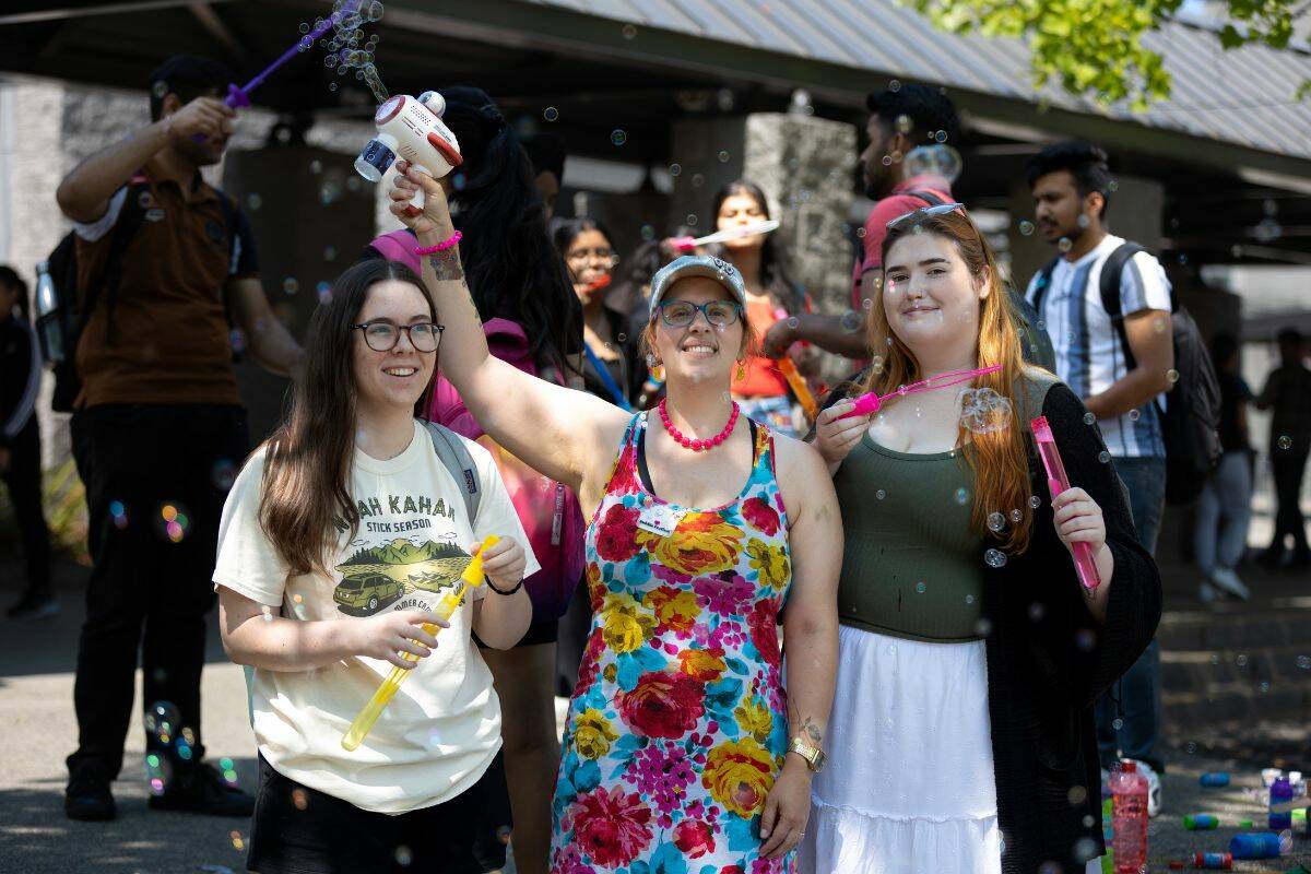 Shyrah Barnaby, left, Dr. Rebecca Yoshizawa, and Makayla Rosenquist pose for a photo at the âSpontaneous Bubble Festivalâ at KPUâs Surrey campus on Thursday, July 20, 2023. (Photo: Anna Burns)