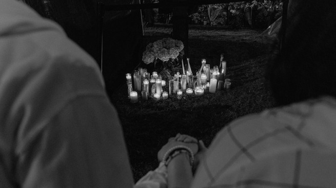 Adzel Marmita holds his daughter's hand at a vigil, four days after a gunman shot and killed multiple people at the Dallas-area Allen Premium Outlets mall in Allen, Texas, U.S. May 10, 2023.