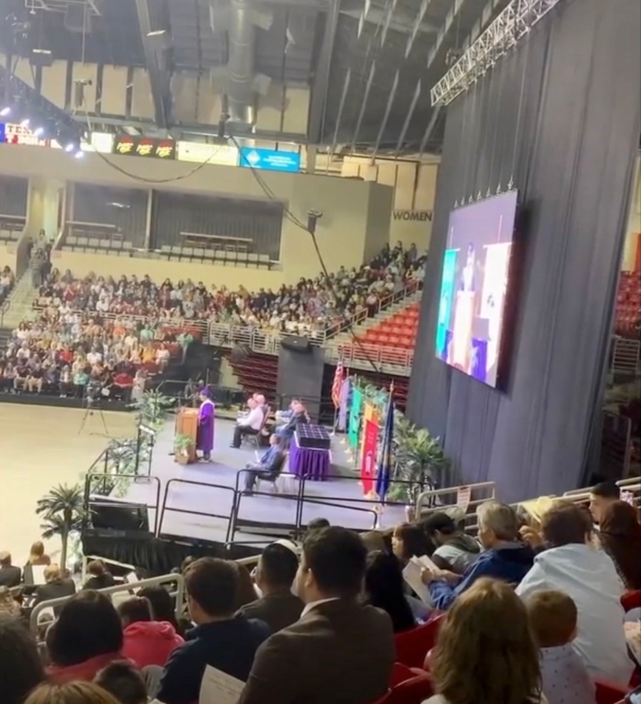 Kenny Morales giving a speech at graduation