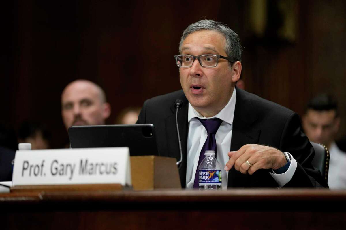 NYU Professor Emeritus Gary Marcus, center, speaks before a Senate Judiciary Subcommittee on Privacy, Technology and the Law hearing on artificial intelligence, Tuesday, May 16, 2023, on Capitol Hill in Washington. Seated alongside Marcus are OpenAI CEO Sam Altman, right, and IBM Chief Privacy and Trust Officer Christina Montgomery.